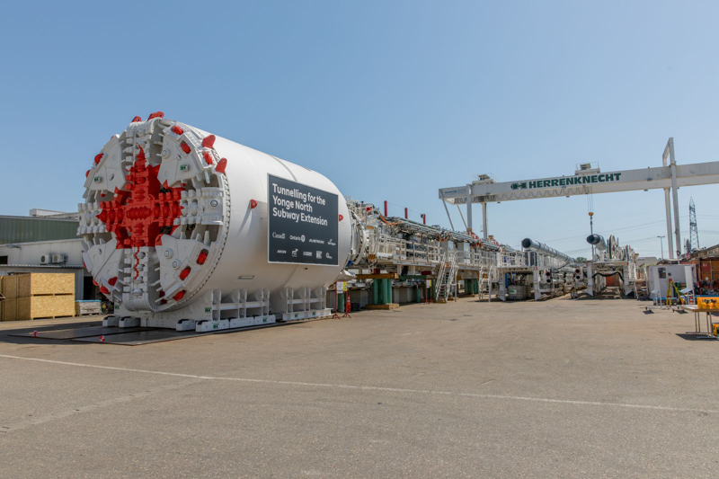 A Yonge North Subway Extension tunnel boring machine stands assembled in an industrial yard.