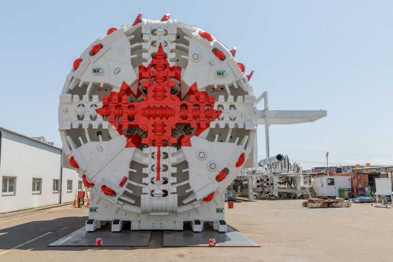 The front view of a Yonge North Subway Extension tunnel boring machine with a red maple leaf symbol displayed on its cutter head.